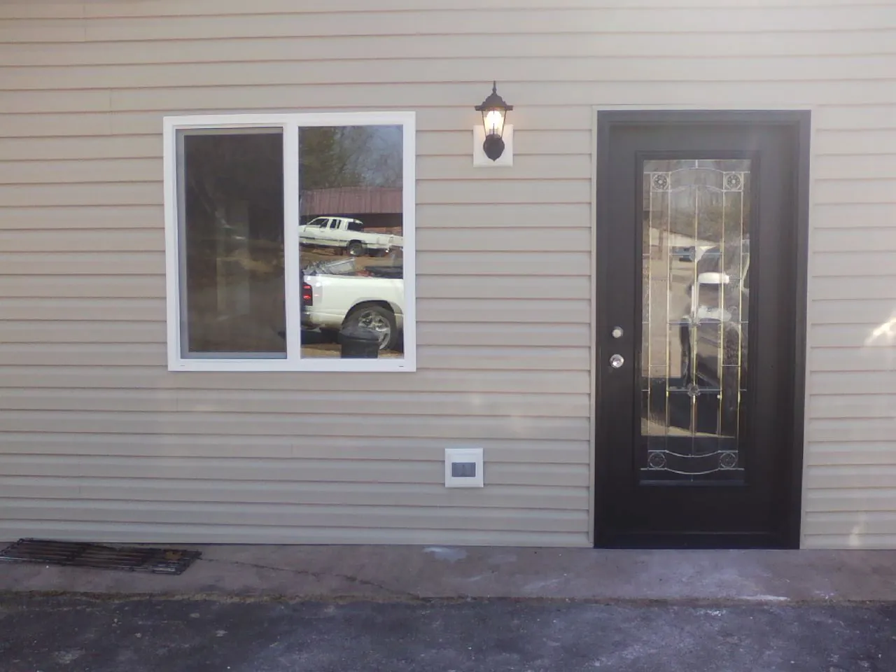 New siding, window and entry door on the side of an addition in Coos Bay